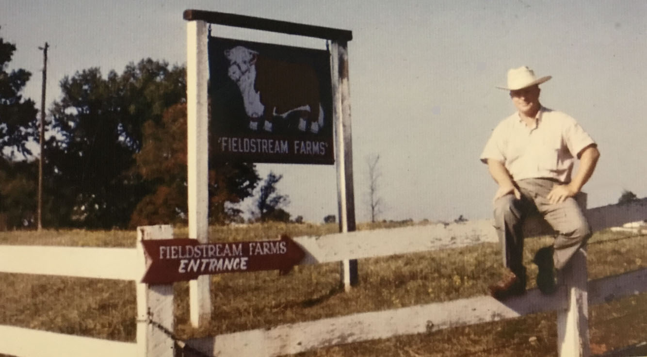 Entrance sign for Freedom Farm with a silhouette of a horse and rider.