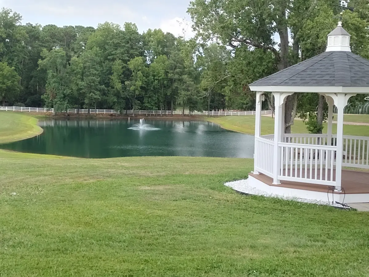 A beautiful lake with a water fountain near a wedding chapel